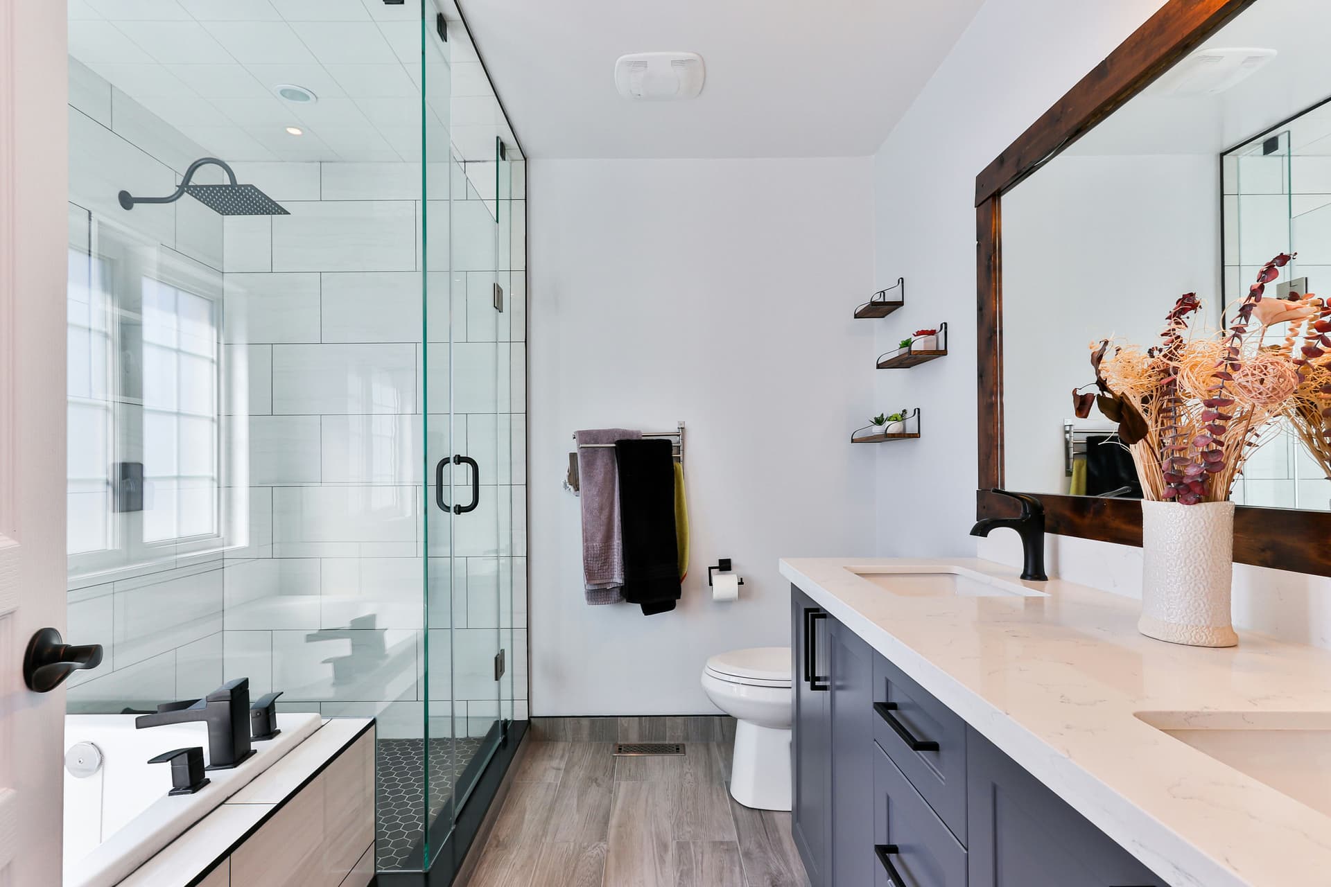 Frameless glass shower enclosure with brushed nickel hardware in renovated Hoboken brownstone